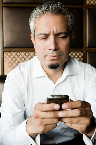portrait of  businessman using his mobile phone stock photo