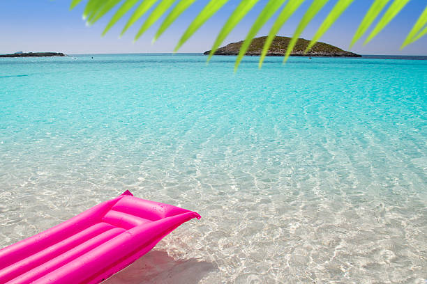 beach floating pink lounge in tropical sea of Formentera Balearic island