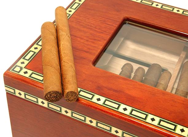 istock Two cigars on a wooden humidor box 153530402