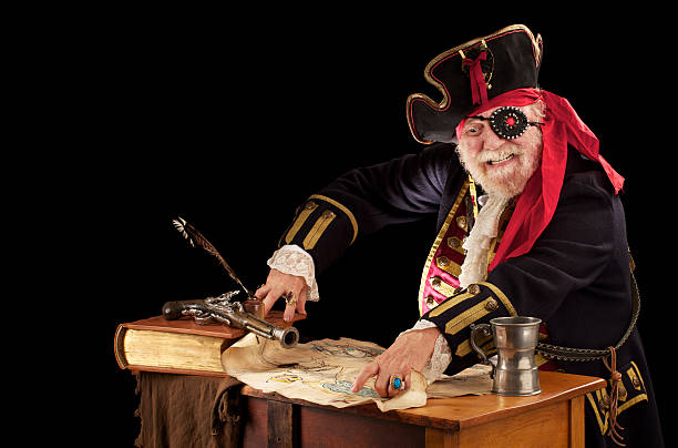 istock Happy old pirate captain pointing at his treasure map 153530525