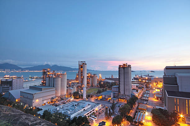 Long view of concrete plant at dusk or dawn Cement Plant,Concrete or cement factory, heavy industry or construction industry. cement factory stock pictures, royalty-free photos & images