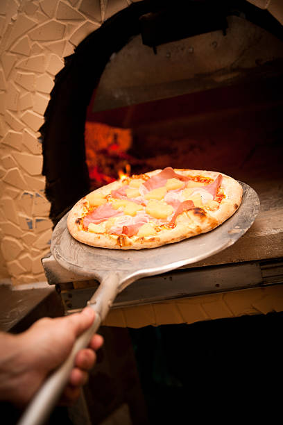 istock Pizza coming out of a Oven 153530673