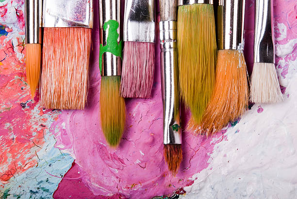 A color paint palette and paintbrushes