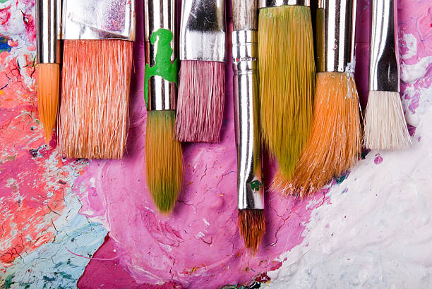 A color paint palette and paintbrushes stock photo
