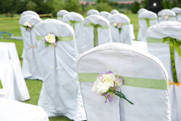 Row of decorated chairs on a outdoor wedding stock photo