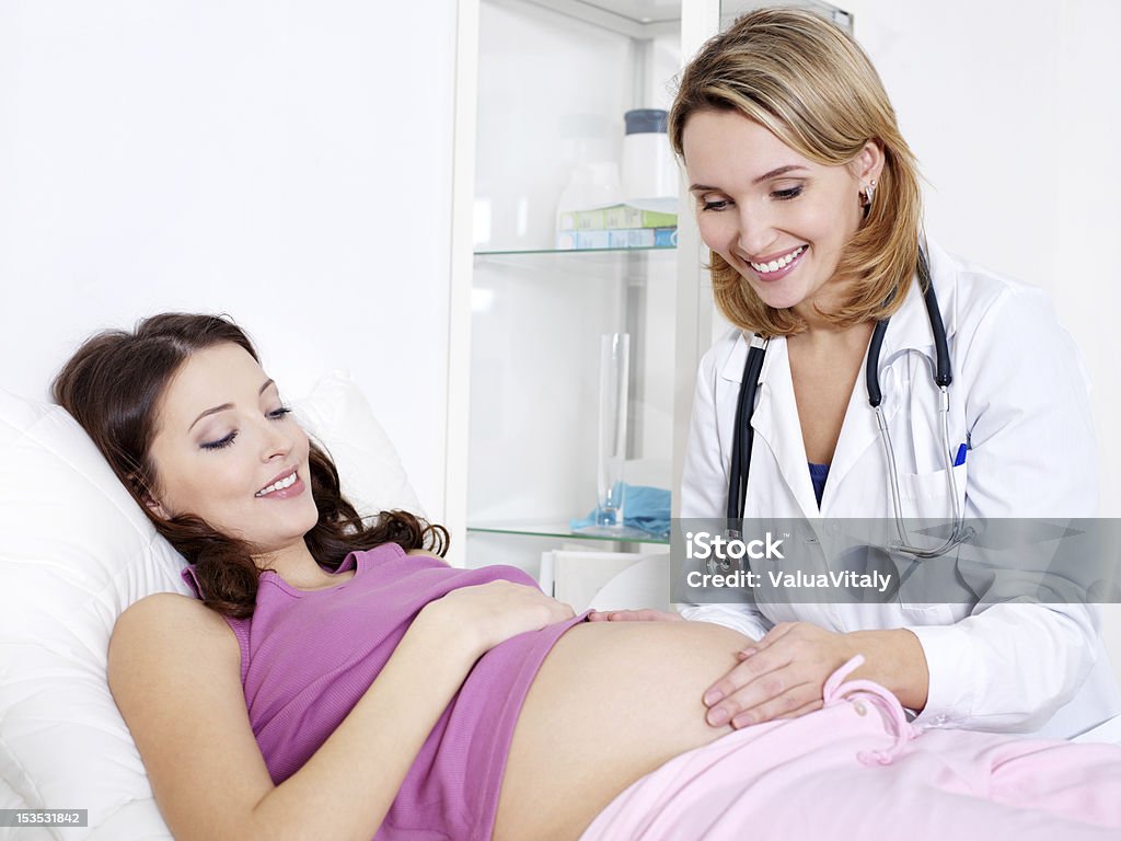 Care about pregnant woman Doctor Care about young pregnant woman in hospital - indoors Pregnant Stock Photo