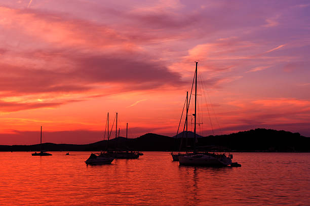 Yachts and boats at Adriatic sea bay in sunset light. stock photo