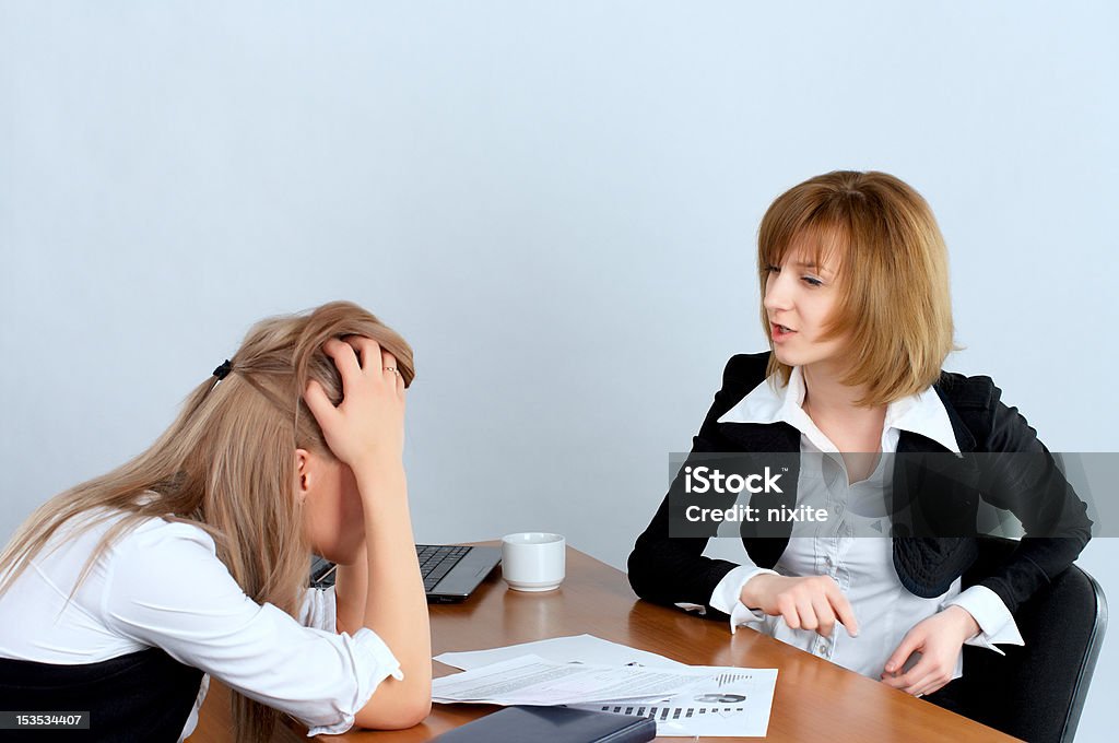 Female executive rebukes secretary Female executive rebukes secretary in the office Adult Stock Photo