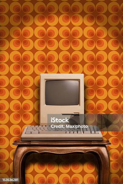 Old Desktop Computer On Wooden Table And Seventies Wallpaper Stock Photo - Download Image Now
