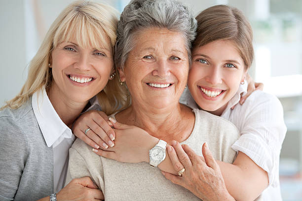 Three female generations. Three generations of woman hugging and looking at camera. granddaughter photos stock pictures, royalty-free photos & images