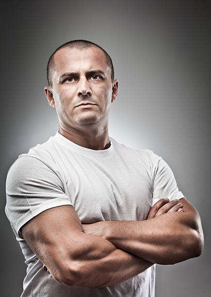 Menacing man portrait Fine art portrait of a menacing man, studio close up machos stock pictures, royalty-free photos & images