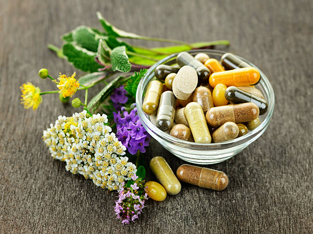 Herbal medicine and herbs Herbs with alternative medicine herbal supplements and pills the natural world stock pictures, royalty-free photos & images