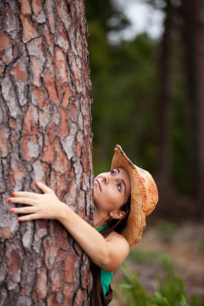 istock Young woman embracing a tree 153538606