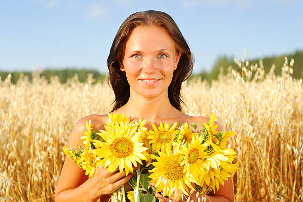istock Young woman with sunflowers 153538717