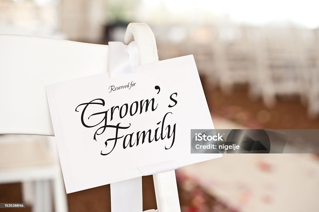 Wedding Place Card Seating Plan on Chair at Ceremony Place card on wedding chair at a wedding ceremony that says Reserved for Groom's Family. Converted from a 14-bit RAW file. Chair Stock Photo