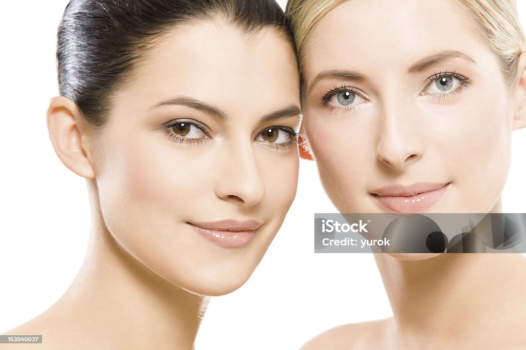 Two young beautiful women posing together studio portrait of two young beautiful women Adult Stock Photo