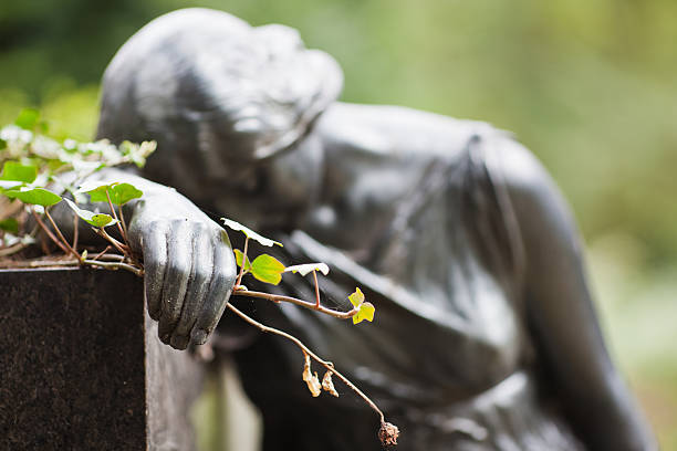 istock dreaming statue with wilted flower in her hand 153540126