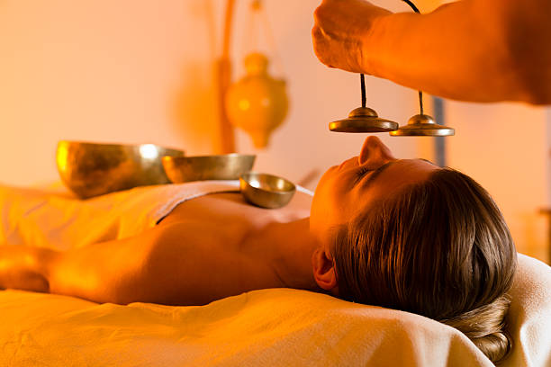 Woman at Wellness massage with singing bowls stock photo