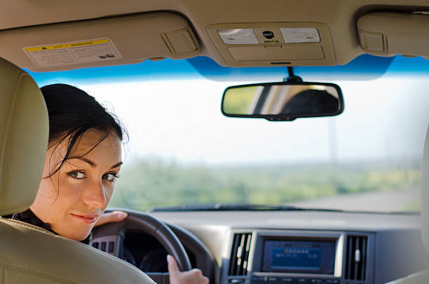 istock Woman driver looking into rear seat 153542702