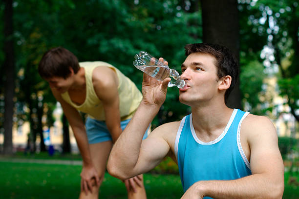 istock Two young sportmen resting outdoors 153542963