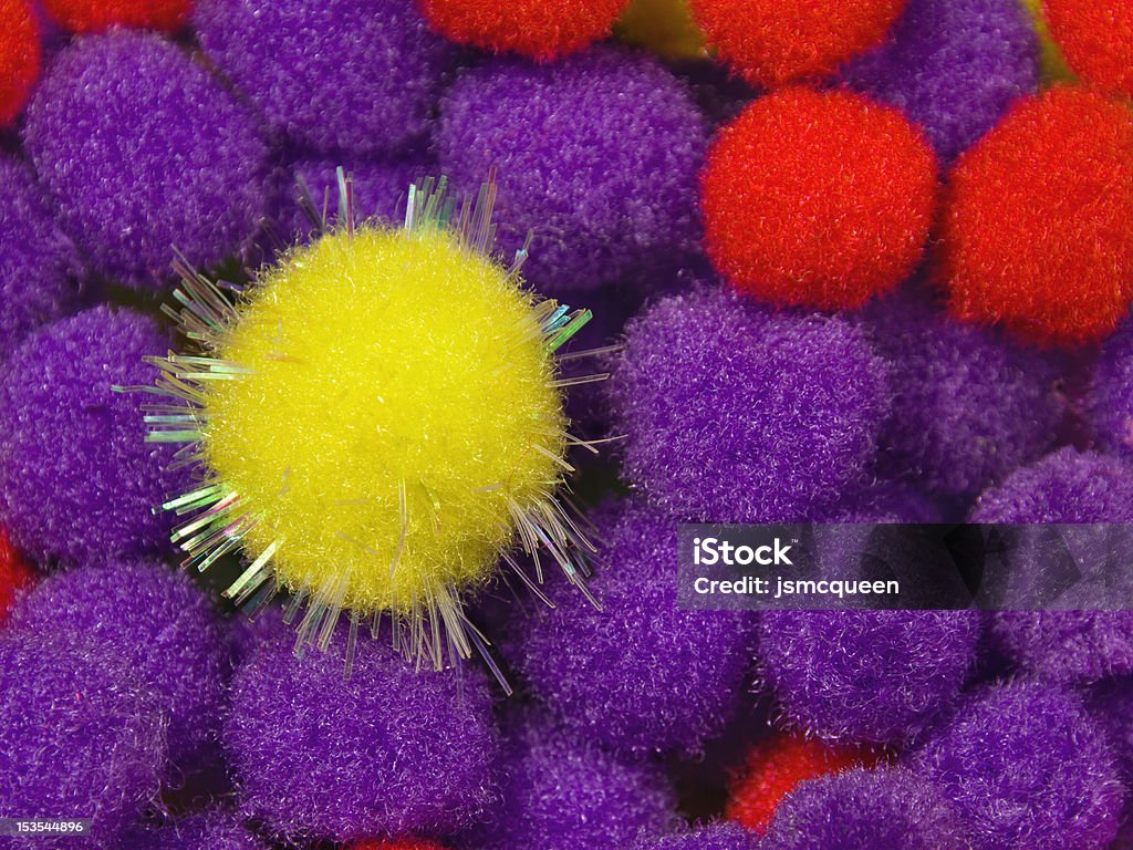 Yellow Shiny Foam Ball A yellow shiny foam ball with blue and red foam balls in the background Blue Stock Photo