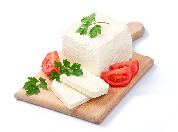 White Bulgarian cheese, arranged with tomatoes and parsley White Bulgarian cheese, arranged with tomatoes and parsley on cutting board white cheese stock pictures, royalty-free photos & images