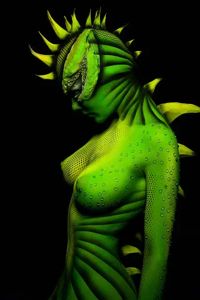 painted in the form of a fluorescent woman-dragon on the black background