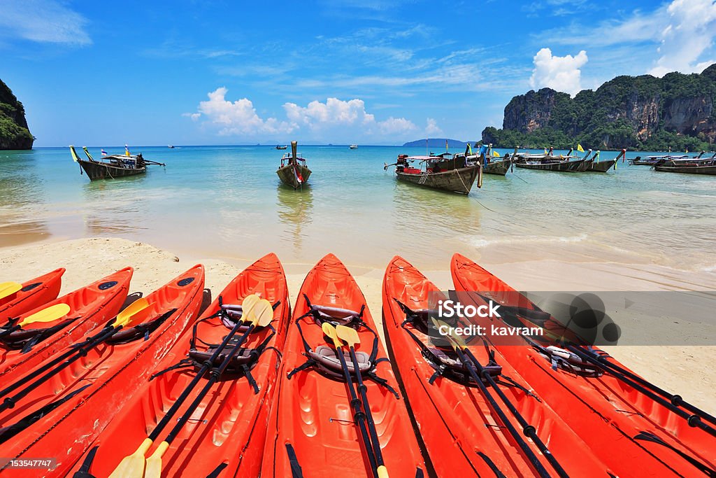 Red modern canoes and boats  Longtail Red modern boats - canoes and boats antique Longtail on a beach in Thailand Andaman Sea Stock Photo