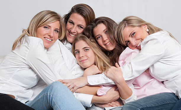 Loving female group A group of 5 happy women of different ages cuddling 40âs stock pictures, royalty-free photos & images