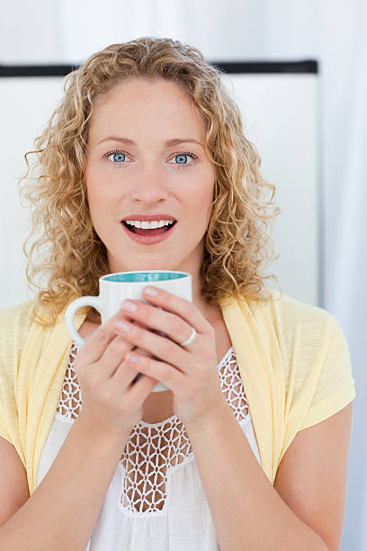istock Pretty woman drinking tea in her kitchen 153549699
