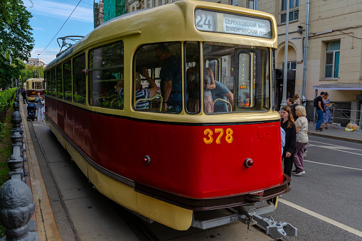 Visitors to the exhibition of old trams study the aft part of the car on the street. Moscow. Chistoprudny Boulevard. 08.07.2023