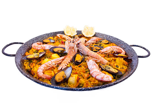 Cast iron dish filled with delicious paella stock photo