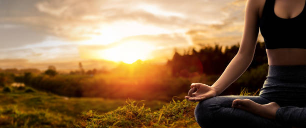 istock Young woman practicing yoga in sunset time 1535518492