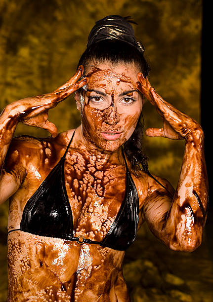 istock beautiful brunette with her naked body covered  chocolate 153551897