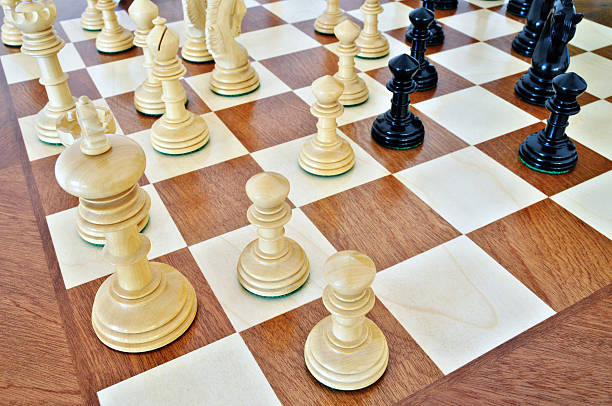 Chess pieces on wood board stock photo