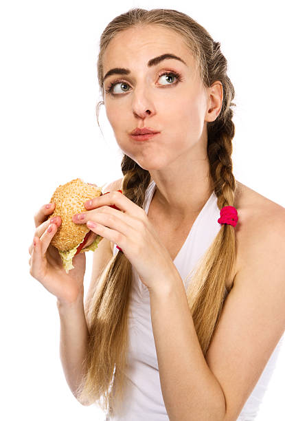 istock Young woman holding a hamburger 153553987