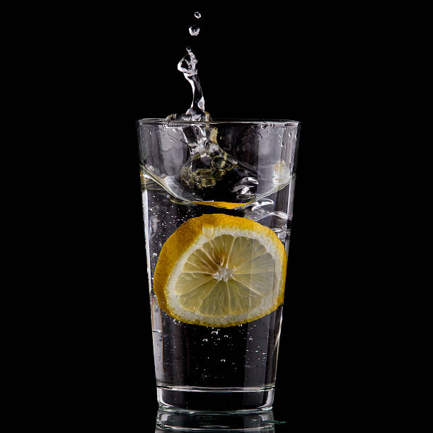 istock Half of lemon falling down in glass 153554941