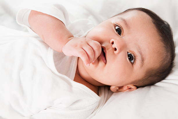 baby girl lost in deep thoughts stock photo