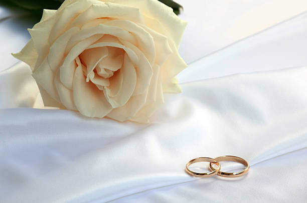 istock Wedding rings and a tea rose 153556165