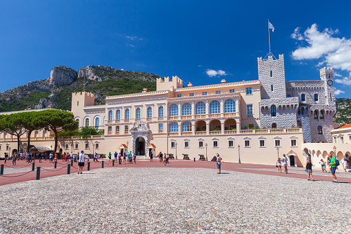 Monte Carlo, Monaco - August 15, 2018: The Prince Palace of Monaco in Monaco-Ville, tourists walk the street