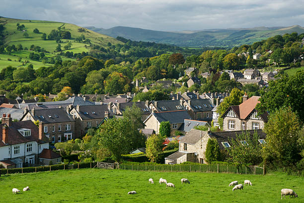 Overlook of a English rural village on a sunny day Overlooking a residential village in The Peak District, Derbyshire. derbyshire photos stock pictures, royalty-free photos & images