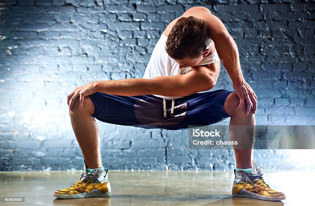 Young man sports exercises Young man sports exercises. On wall background. 20-29 Years Stock Photo