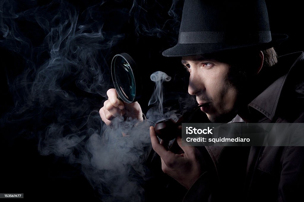 Private Eye Private detective searching for information, isolated on a black background Detective Stock Photo