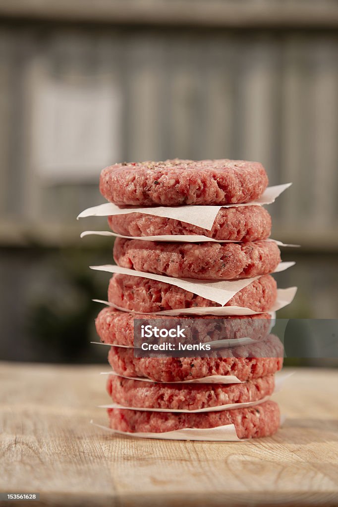 Raw burgers for hamburgers, in a pile Raw burgers for hamburgers, in a pile in a garden Hamburger Stock Photo