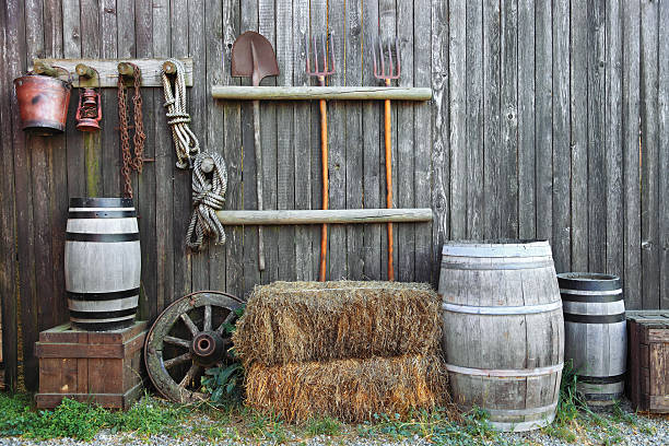 barrel bale and pitchfork in old barn stock photo