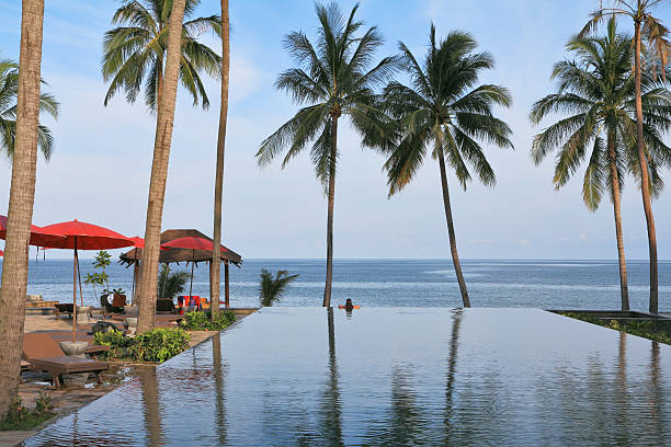 istock Beach pavilion with red roofs, palm trees 153562512