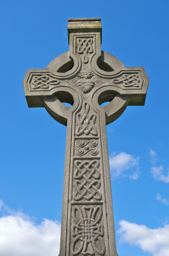 Example of pre 1900 irish celtic cross with traditional celtic carving detail from a grave in the famous landmark Milltown Cemetery Belfast, which is the largest Catholic burial ground in Belfast and synonymous with Irish Republicanism.