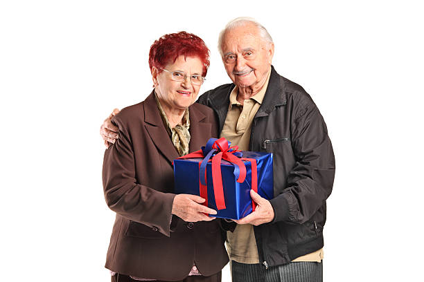 istock Senior couple holding a gift 153564162