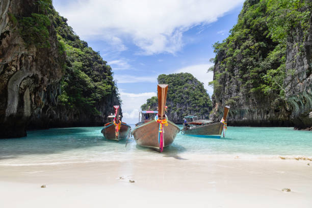 istock Traditional longtail boat with beautiful scenery view at Maya Bay on Phi Phi Leh Island in sunshine day. 1535643830