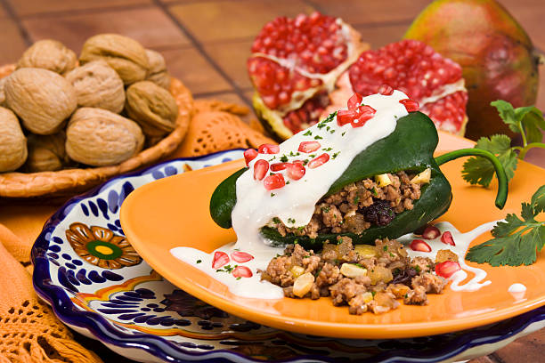 Stuffed green peppers with walnut sauce stock photo